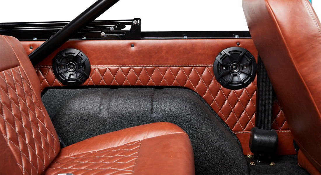Classic Ford Bronco dashboard speedometer detail with white face, black numbers, and needle reading zero