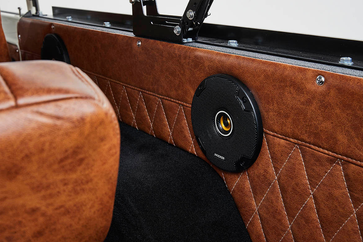 Brown quilted panel with round black speaker inside Classic Ford Bronco interior