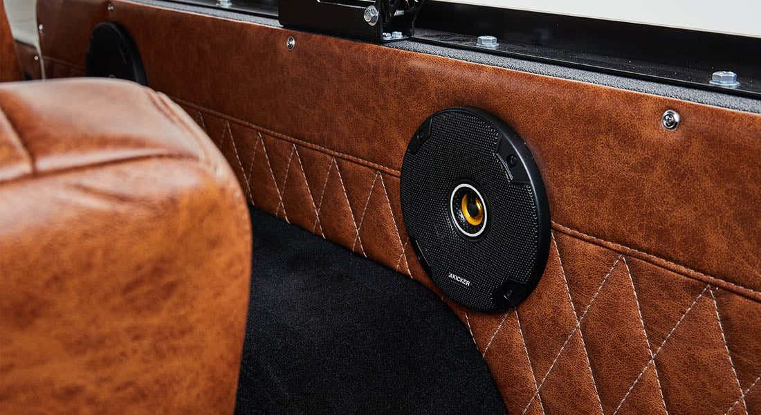 Classic Ford Bronco interior speaker mounted in brown quilted panel behind seats