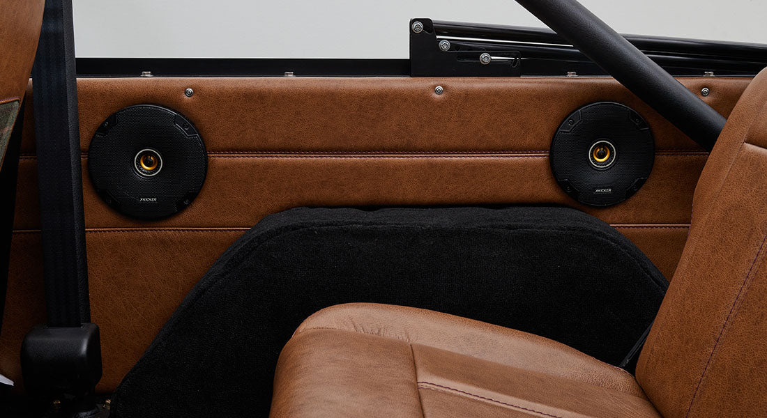 Brown leather interior door panel with two black round speakers inside Classic Ford Bronco