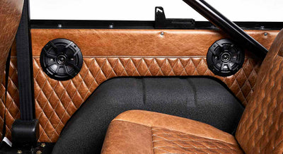 Brown quilted leather interior with speakers and seatbelt in Classic Ford Bronco