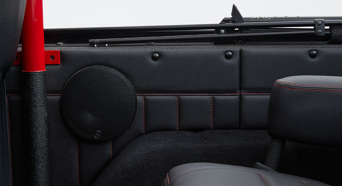 Black JL Audio speaker mounted inside a Classic Ford Bronco door panel