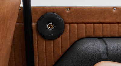Classic Ford Bronco interior door panel with brown leather and black round speaker