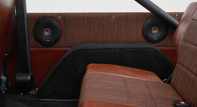Brown leather and woven fabric armrest with black base inside Classic Ford Bronco