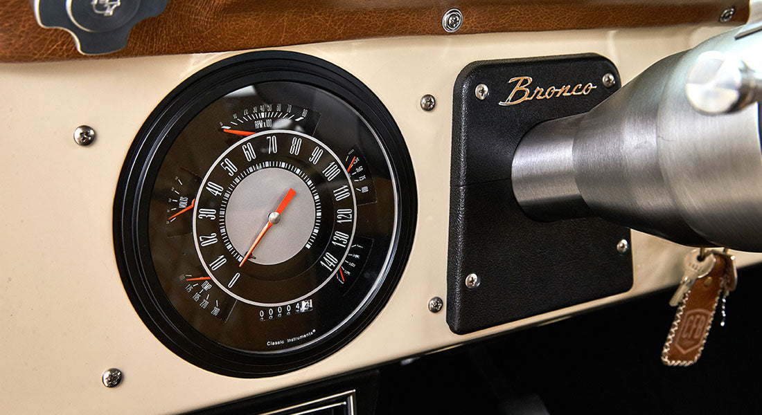 Dashboard of Classic Ford Bronco with speedometer and Bronco badge