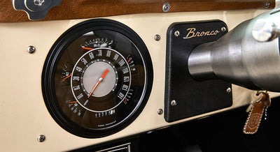 Dashboard of Classic Ford Bronco with speedometer and Bronco badge