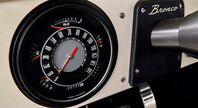 Classic Ford Bronco speedometer with black dial and red needle