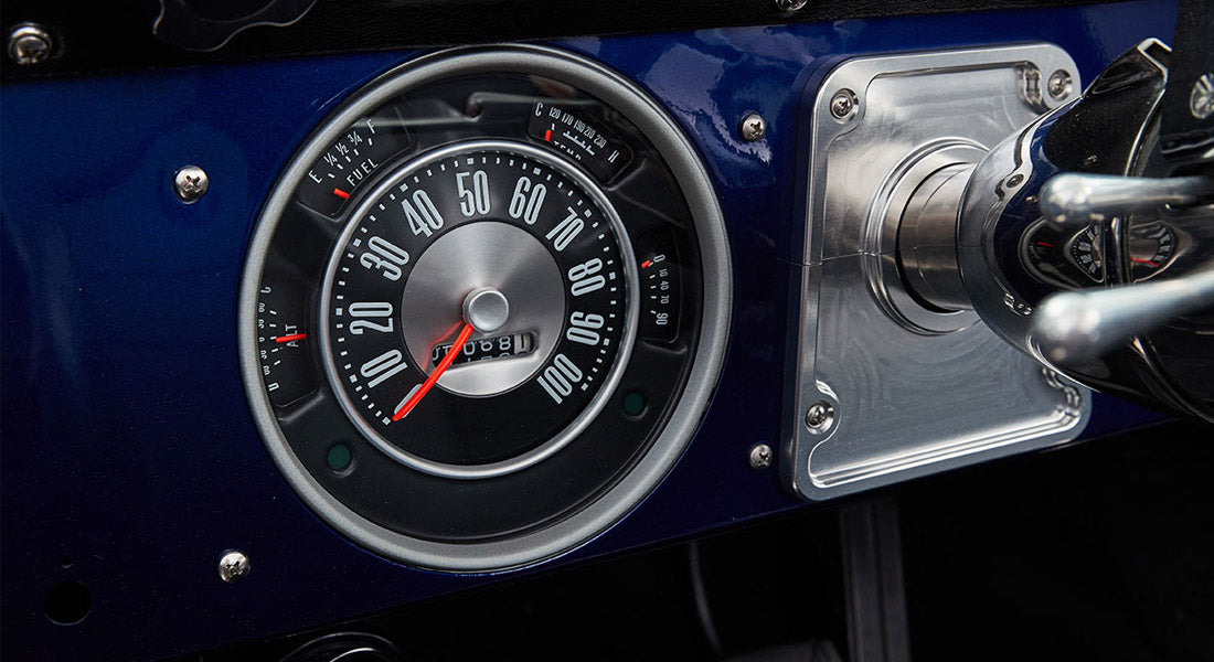 Classic Ford Bronco blue dashboard with speedometer, fuel gauge, and metal trim