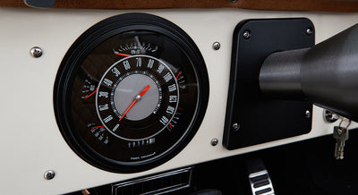 Classic Ford Bronco speedometer gauge showing speed, odometer, and fuel level on white dashboard