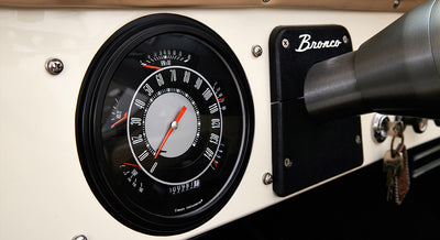 Classic Ford Bronco dashboard speedometer with black bezel and beige background