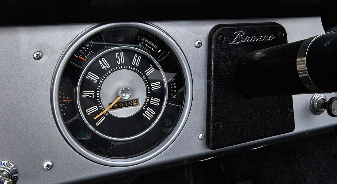 Classic Ford Bronco speedometer with odometer reading 676015 miles on gray and black dash