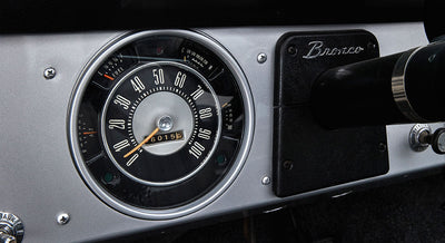 Classic Ford Bronco speedometer with odometer reading 676015 miles on gray and black dash