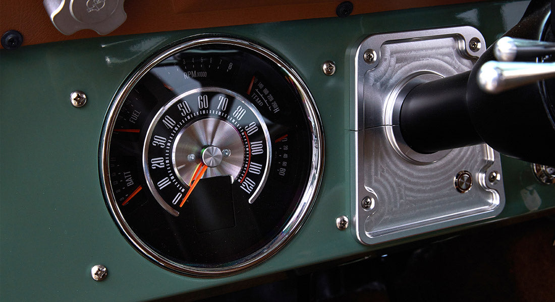 Speedometer and tachometer gauge in green Classic Ford Bronco dashboard