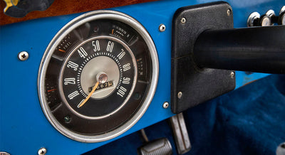 Speedometer gauge with fuel and temperature indicators on blue Classic Ford Bronco dashboard
