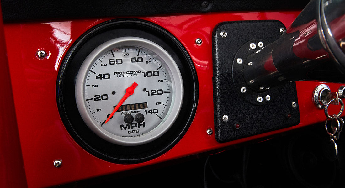 Speedometer dial showing up to 140 MPH inside a Classic Ford Bronco