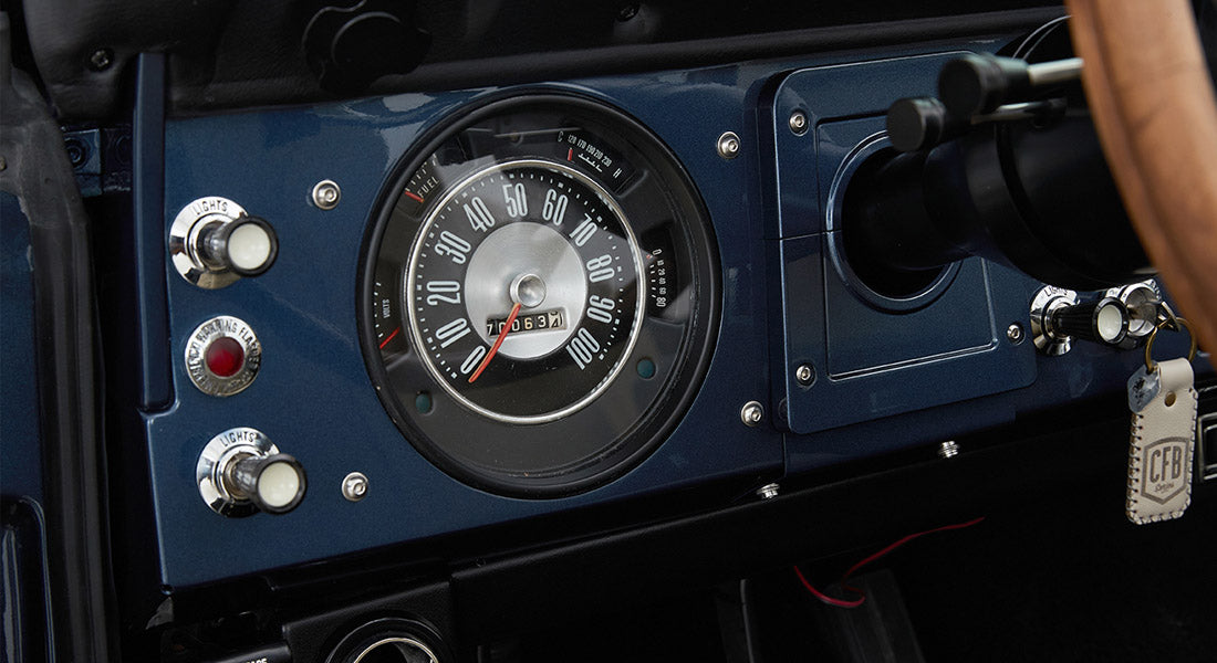 Classic Ford Bronco dashboard with speedometer and ignition key with keychain