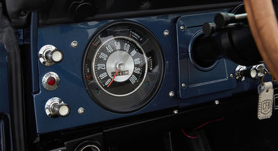 Classic Ford Bronco dashboard with speedometer and ignition key with keychain