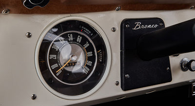 Classic Ford Bronco speedometer showing zero and a section of dashboard with Bronco nameplate