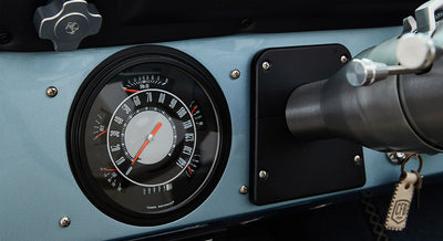 Classic Ford Bronco dashboard speedometer and gauge cluster with black bezel and blue panel