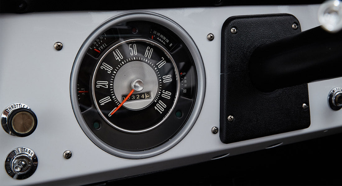 Classic Ford Bronco dashboard speedometer with fuel and temperature gauges and white background