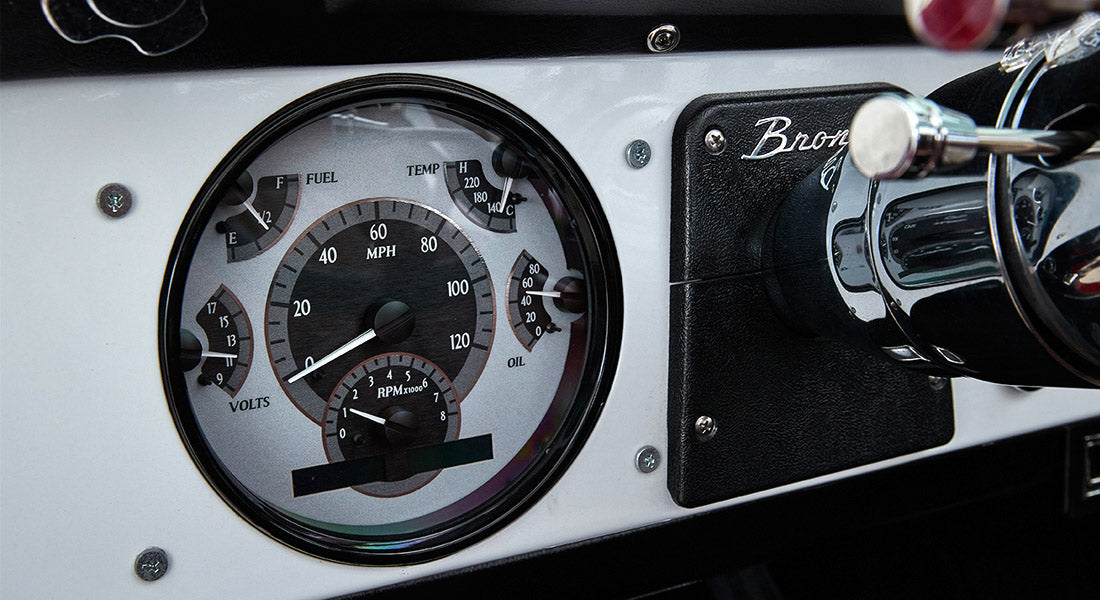 Classic Ford Bronco dashboard speedometer and gauges with white background
