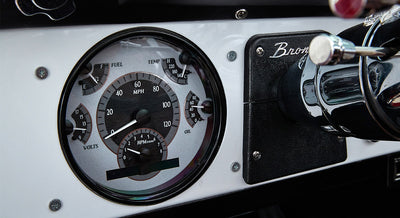 Classic Ford Bronco dashboard speedometer and gauges with white background