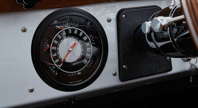 Speedometer gauge cluster showing speed and various indicators inside Classic Ford Bronco