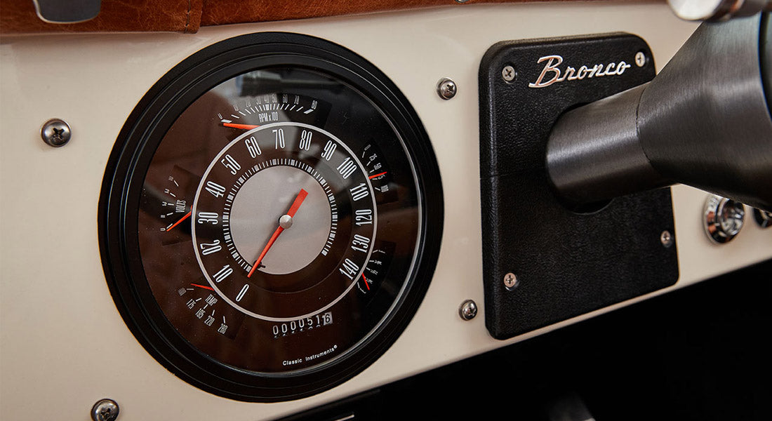 Classic Ford Bronco speedometer and tachometer with Bronco nameplate on white dashboard