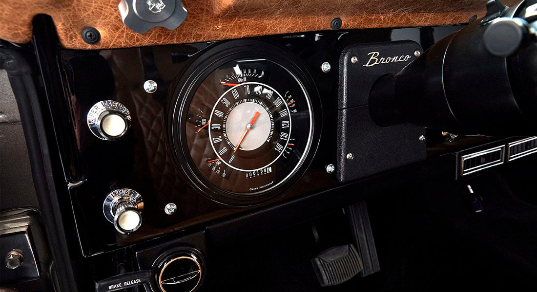 Classic Ford Bronco black dashboard with speedometer and Bronco nameplate