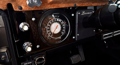 Classic Ford Bronco black dashboard with speedometer and Bronco nameplate