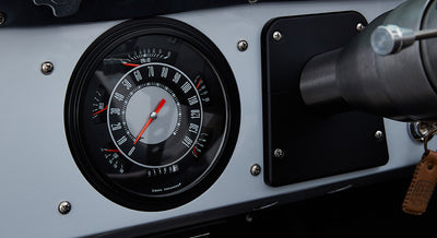 Classic Ford Bronco speedometer gauge showing zero speed with black and silver dashboard surrounding