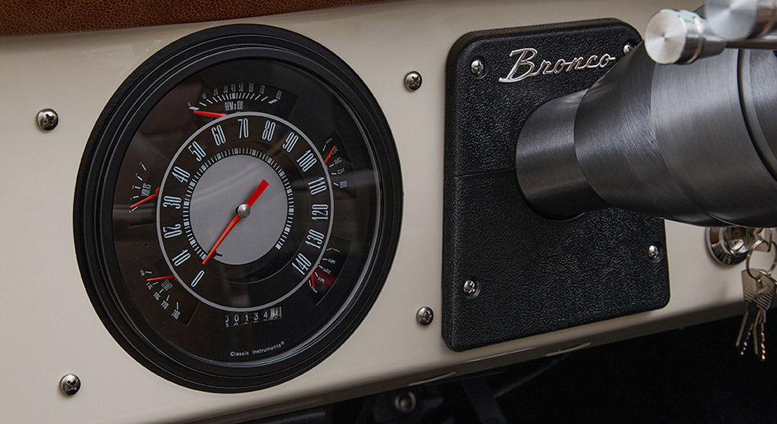 Round speedometer gauge and Bronco nameplate on dashboard of Classic Ford Bronco