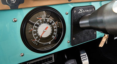 Classic Ford Bronco speedometer and tachometer in turquoise dashboard