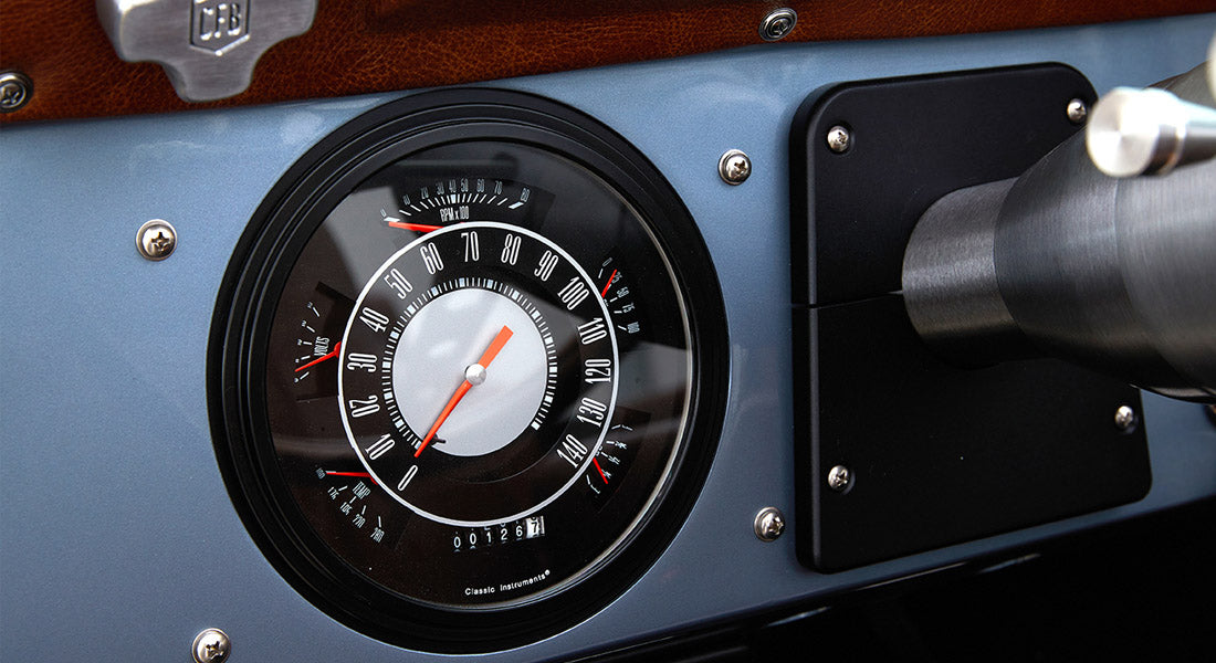 Classic Ford Bronco speedometer showing zero miles and RPMs on blue dashboard