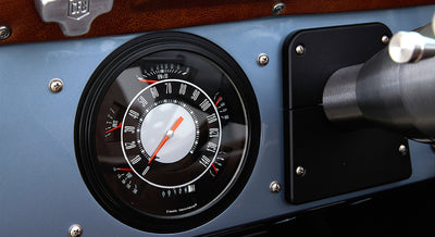 Classic Ford Bronco speedometer showing zero miles and RPMs on blue dashboard
