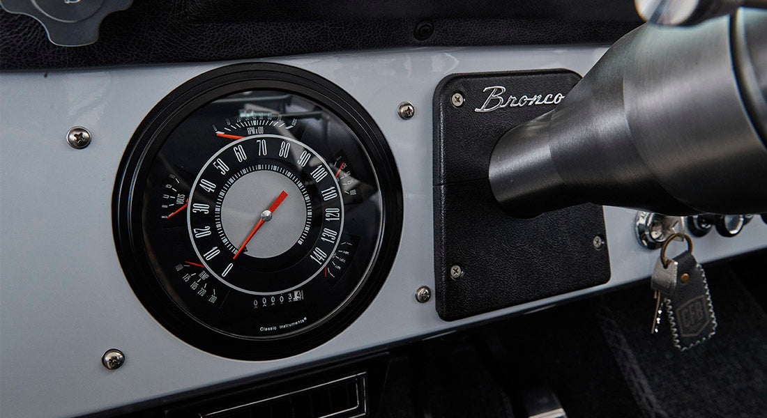 Classic Ford Bronco dashboard with speedometer and Bronco nameplate