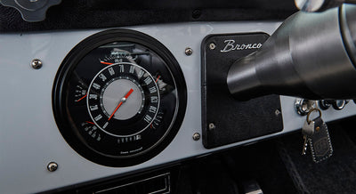 Classic Ford Bronco dashboard with speedometer and Bronco nameplate