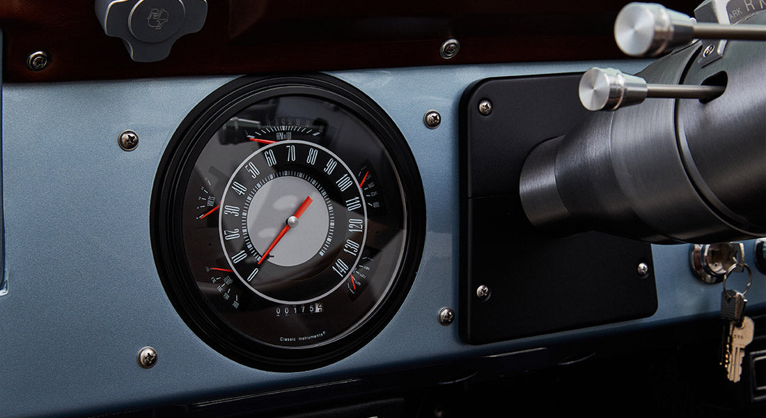 Classic Ford Bronco dashboard speedometer with white numbers and red needles