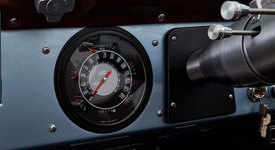 Classic Ford Bronco dashboard speedometer with white numbers and red needles