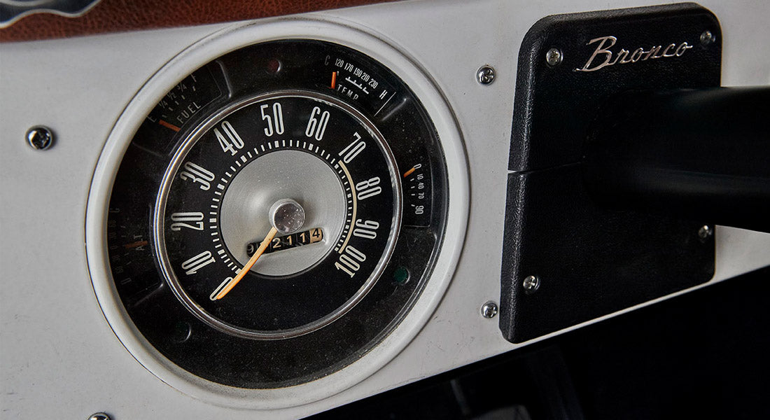 Vintage speedometer with odometer reading 972114 and small Bronco emblem on dashboard