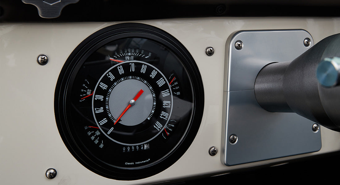 Black and silver Classic Instruments speedometer on vehicle dashboard of Classic Ford Bronco.