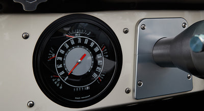 Black and silver Classic Instruments speedometer on vehicle dashboard of Classic Ford Bronco.