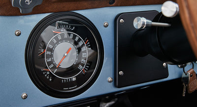 Round speedometer gauge on a blue Classic Ford Bronco dashboard with red needle pointing at zero