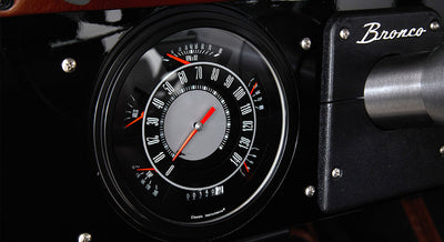 Close-up of a Classic Ford Bronco speedometer and RPM gauge with Bronco branding on dashboard