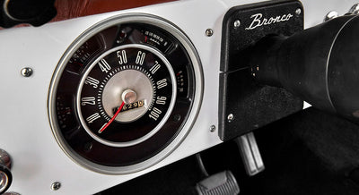 Close-up of Classic Ford Bronco speedometer and instrument gauge cluster on white dashboard