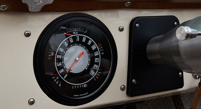 Classic Ford Bronco dashboard speedometer with black and white face and needle