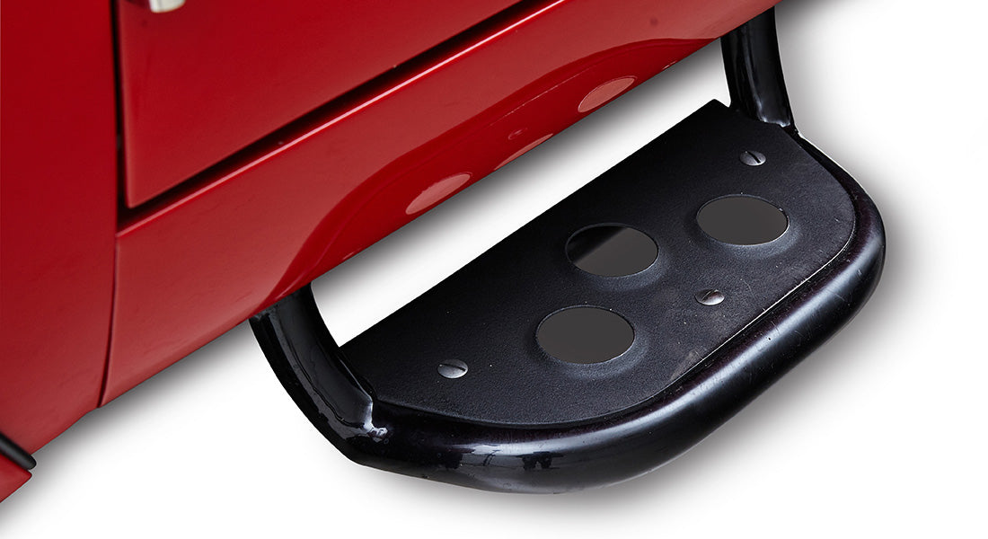 Black metal step attached to the side of a red Classic Ford Bronco
