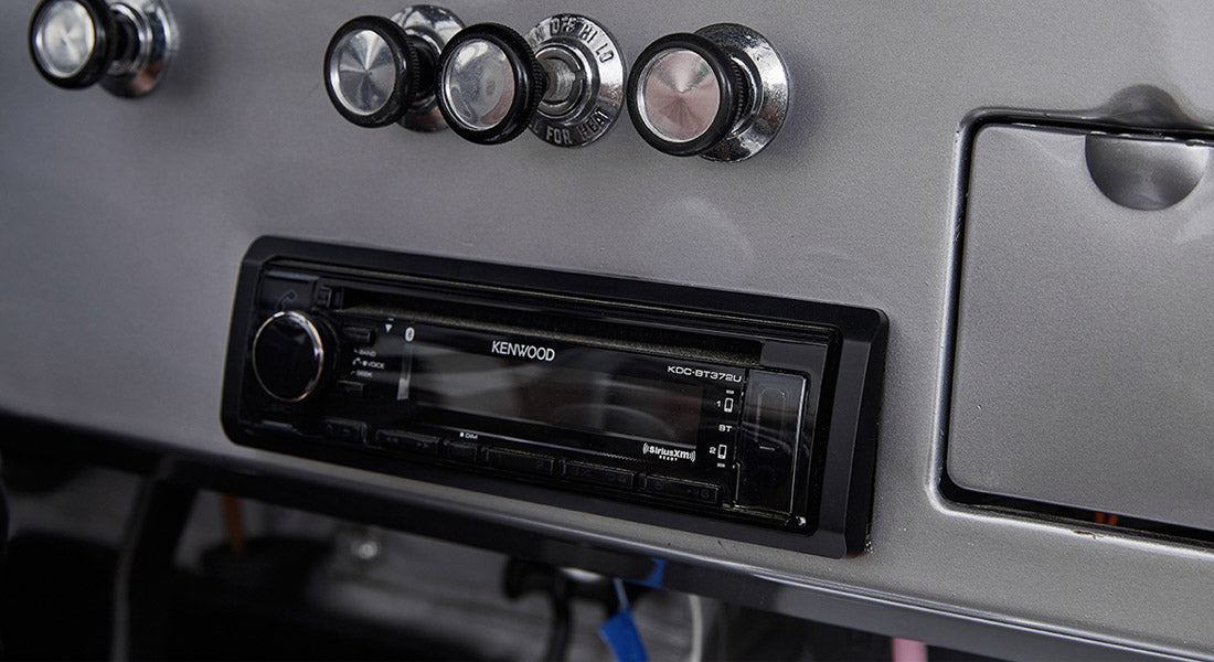 Classic Ford Bronco dashboard with vintage Kenwood stereo system and control knobs