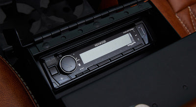 Kenwood stereo system installed in brown leather interior compartment