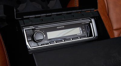 Kenwood stereo system with digital display installed in the center console of a Classic Ford Bronco